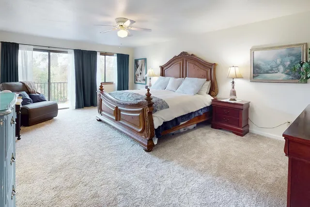 a spacious bedroom with a bed and a couch