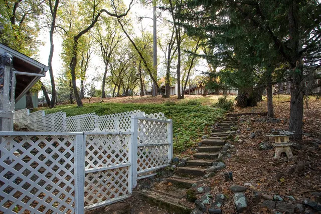 a view of a living room and floor to ceiling window wooden floor