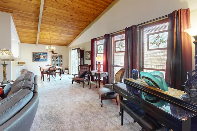 a kitchen with stainless steel appliances granite countertop a refrigerator a sink dishwasher a stove and white cabinets with wooden floor