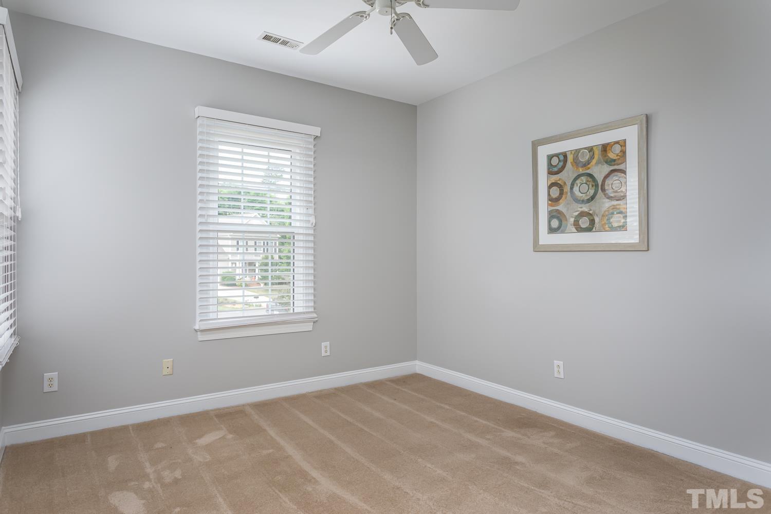 5304 Back Sail Court Raleigh, NC 27613 - Photo 15 of 22 an empty room with a window and a ceiling fan