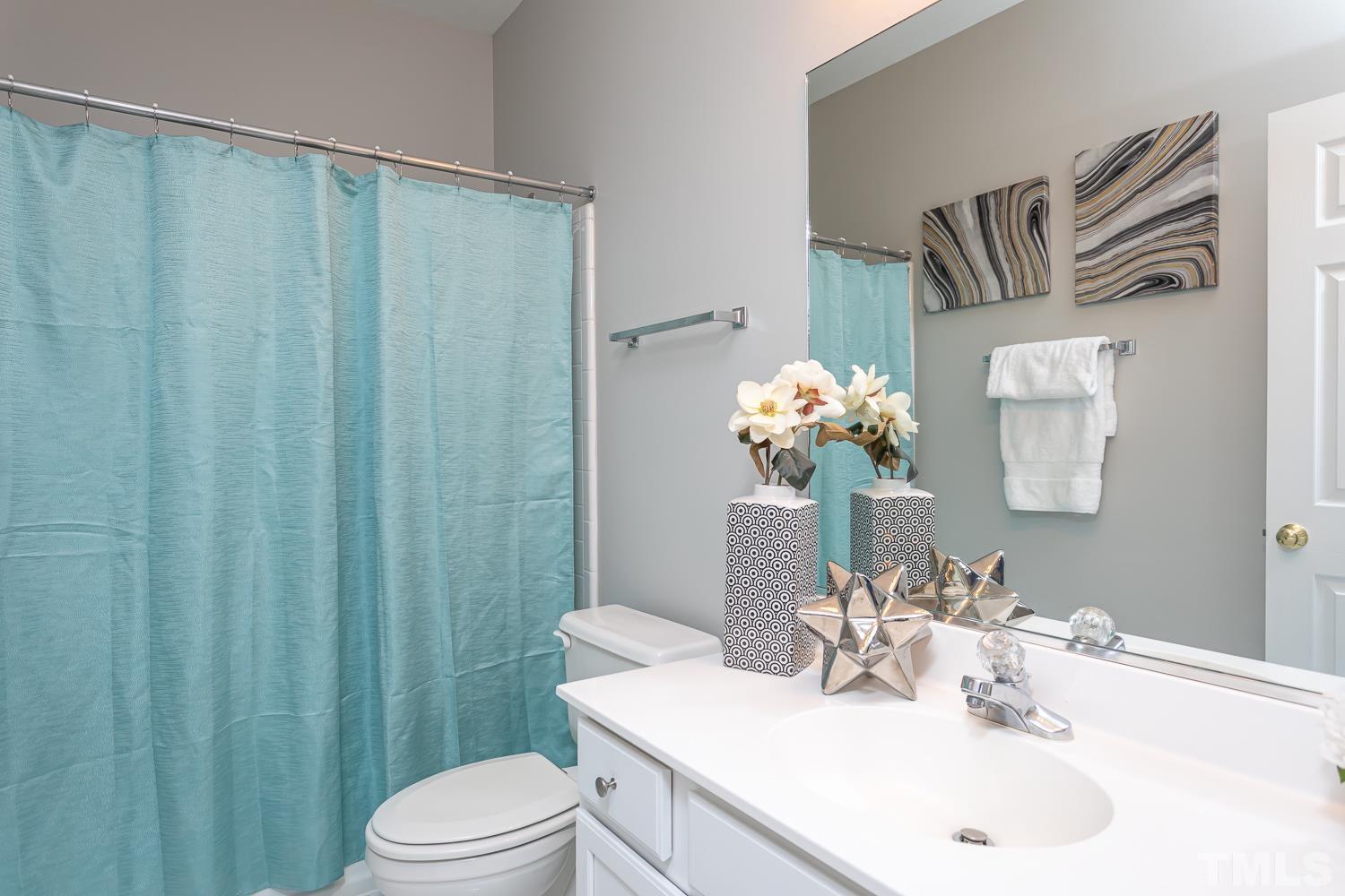 5304 Back Sail Court Raleigh, NC 27613 - Photo 17 of 22 a bathroom with a sink vanity mirror and toilet