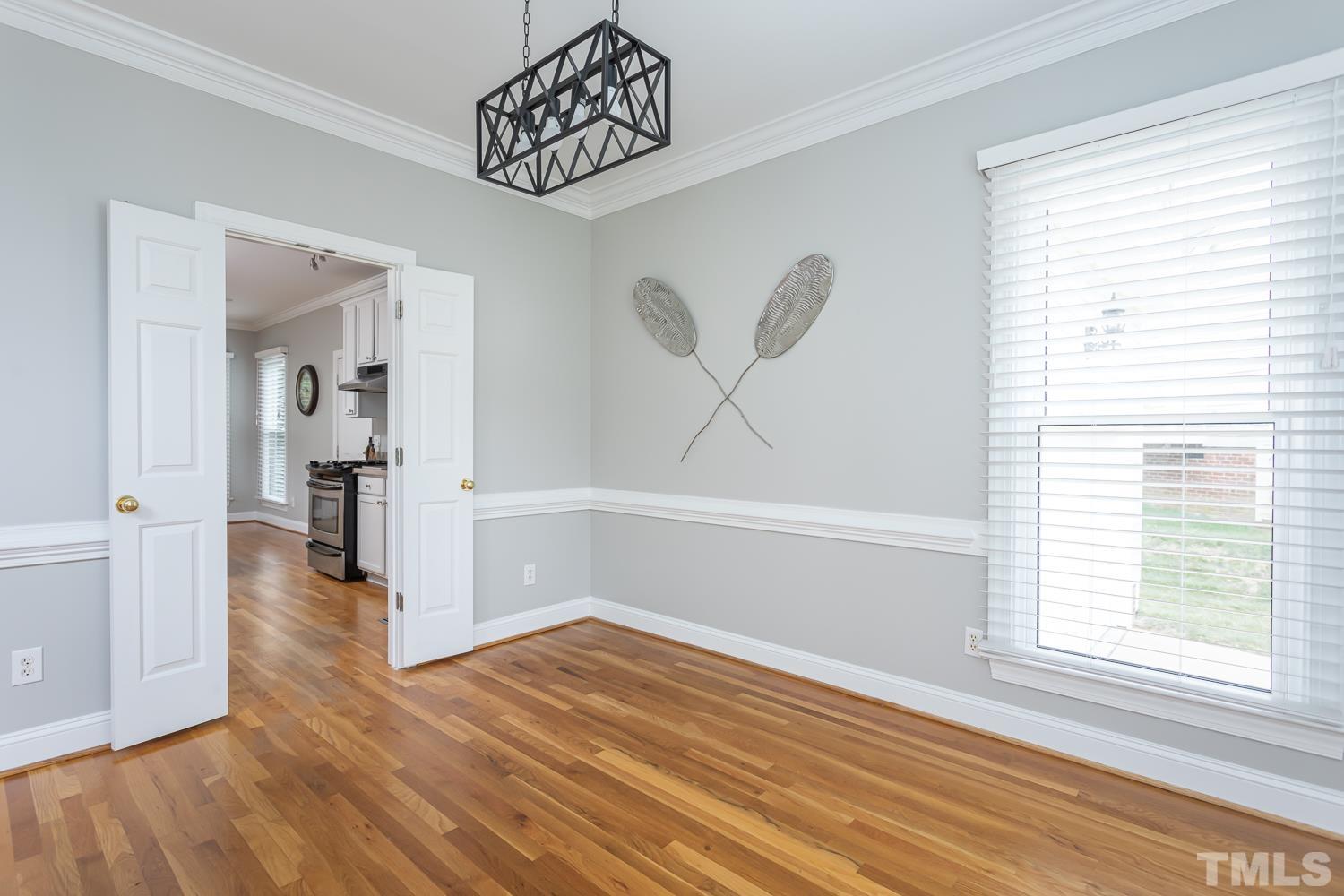 5304 Back Sail Court Raleigh, NC 27613 - Photo 2 of 22 an empty room with wooden floor and windows