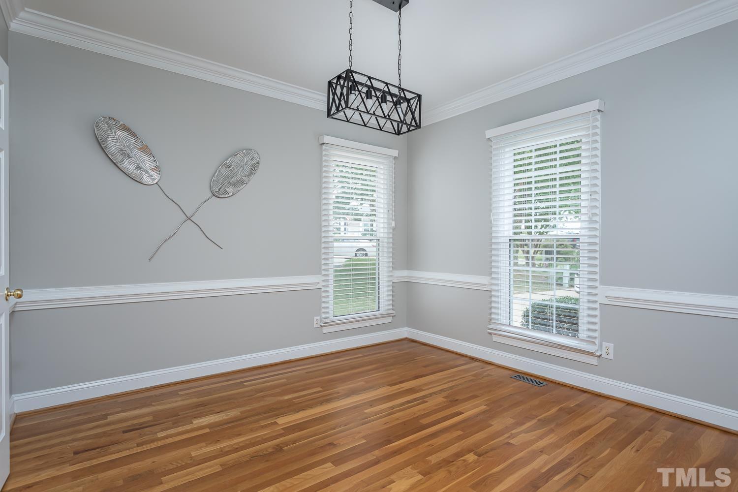 5304 Back Sail Court Raleigh, NC 27613 - Photo 3 of 22 a view of an empty room with wooden floor and a window