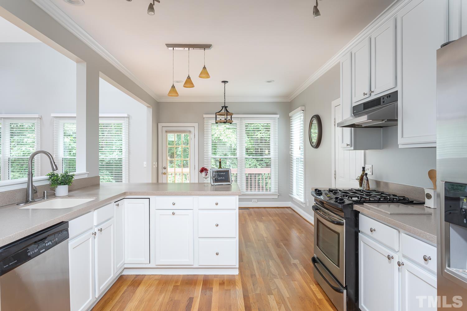 5304 Back Sail Court Raleigh, NC 27613 - Photo 4 of 22 a kitchen with granite countertop a sink stove and cabinets
