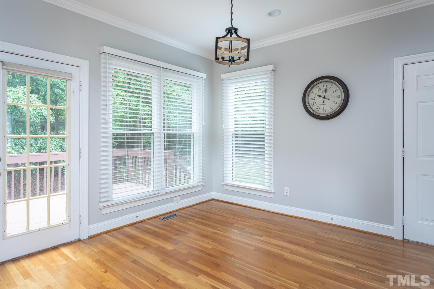 5304 Back Sail Court Raleigh, NC 27613 - Photo 7 of 22 a view of an empty room with wooden floor and a window