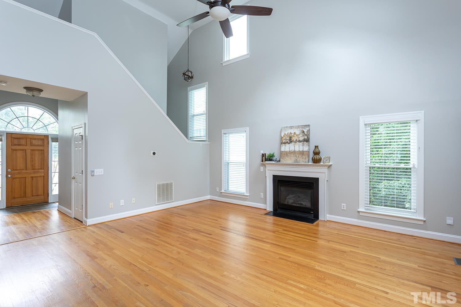 5304 Back Sail Court Raleigh, NC 27613 - Photo 8 of 22 wooden floor fireplace and windows in an empty room