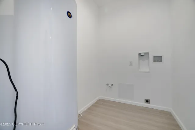 a view of a room with wooden floor and white wall