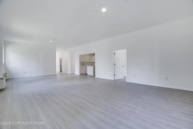 a view of an empty room and wooden floor