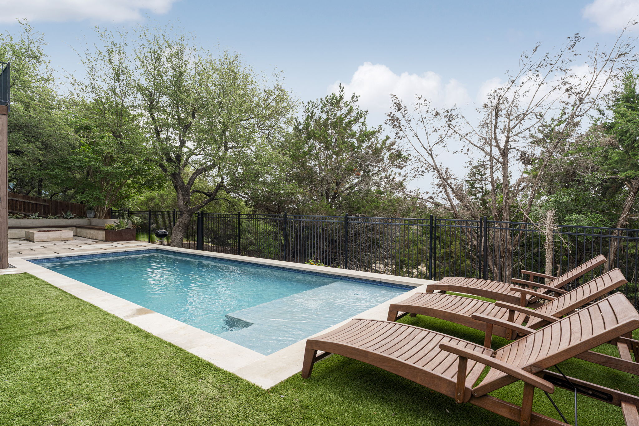 288 Hazy Hills Loop Dripping Springs, TX 78620 - Photo 2 of 40 A special offering, the pool is thoughtfully integrated into the landscape with low-maintenance turf, mature greenery, and unobstructed greenbelt views, creating a true sense of privacy.