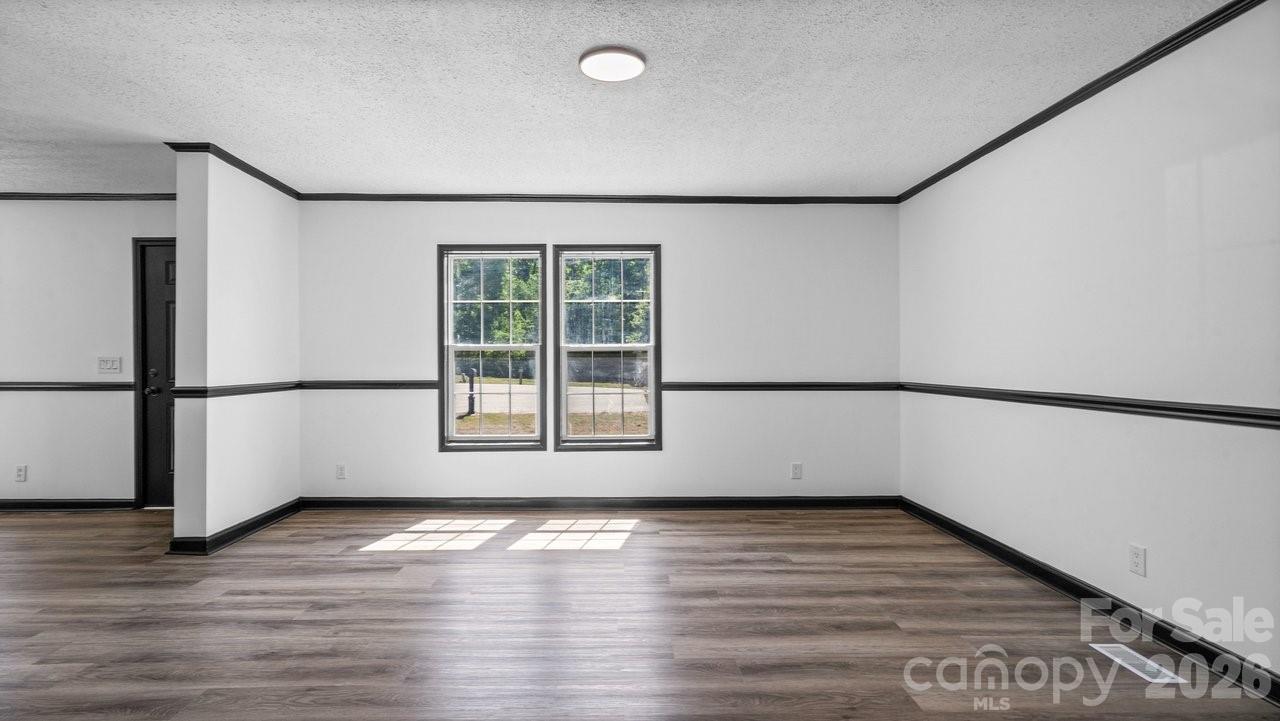 175 Fallsworth Court Salisbury, NC 28147 - Photo 12 of 35 an empty room with wooden floor and windows