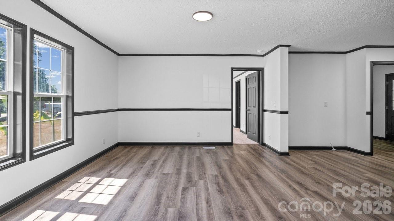 175 Fallsworth Court Salisbury, NC 28147 - Photo 14 of 35 a view of an empty room with wooden floor and a window