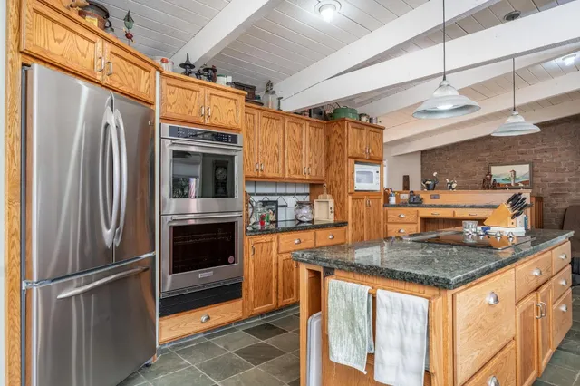 a kitchen with stainless steel appliances granite countertop a stove and a sink