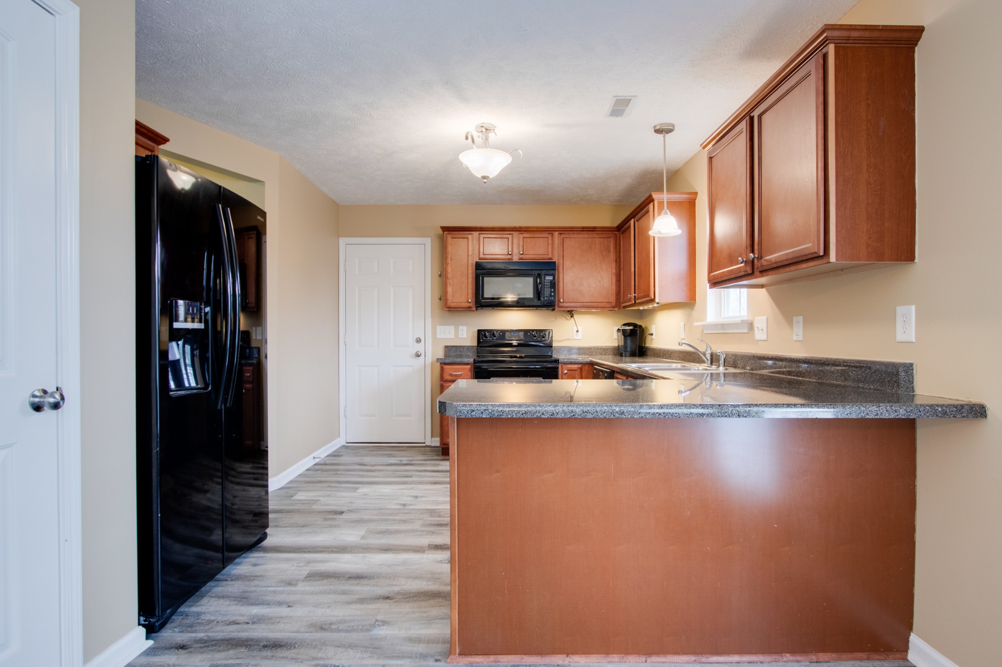 977 Woodall Road Lebanon, TN 37090 - Photo 12 of 32 a kitchen with stainless steel appliances granite countertop a refrigerator and a stove top oven