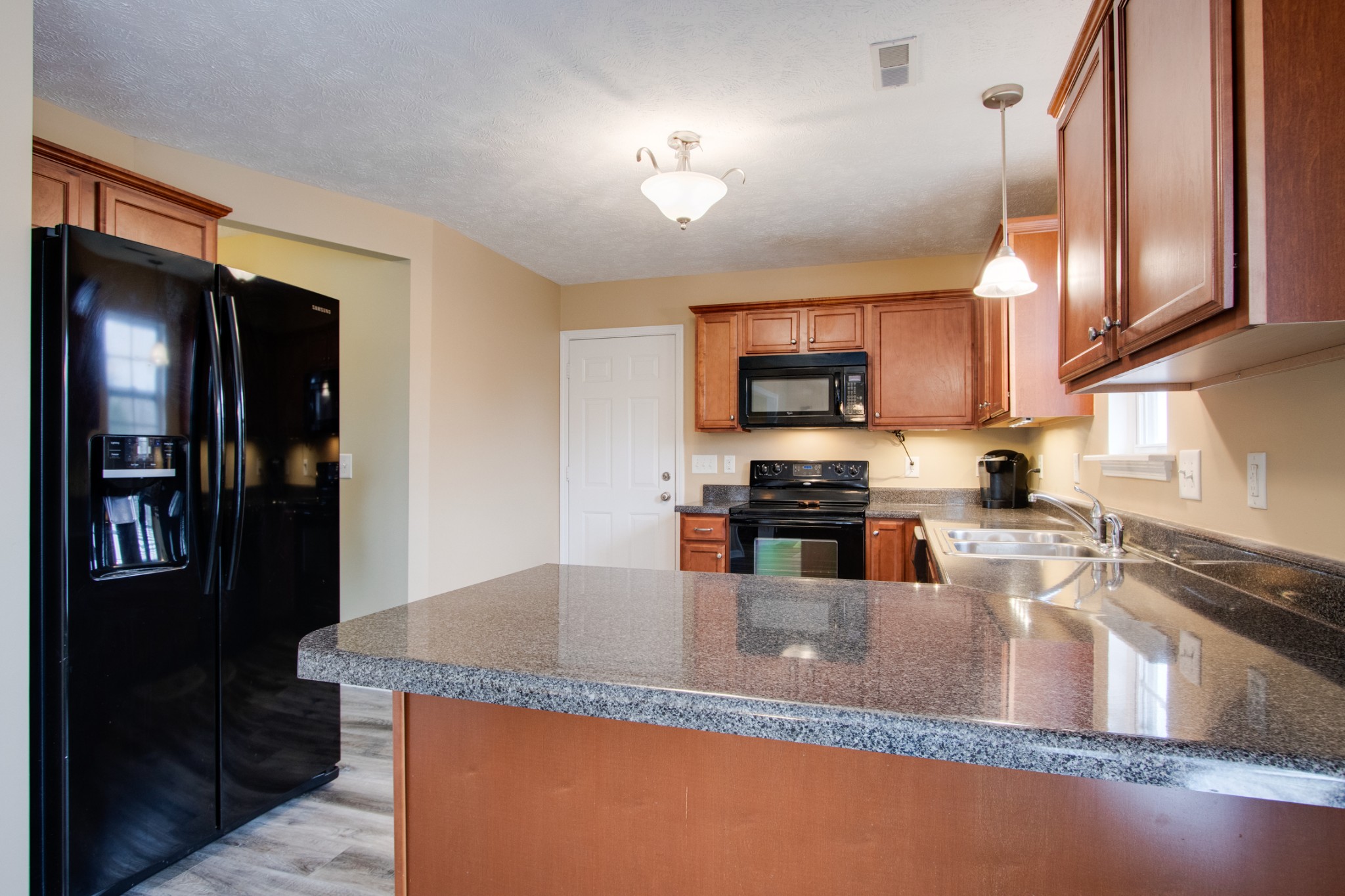 977 Woodall Road Lebanon, TN 37090 - Photo 13 of 32 a kitchen with stainless steel appliances granite countertop a sink a stove and a refrigerator