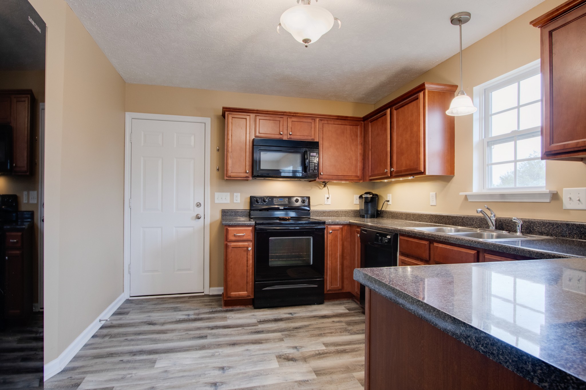 977 Woodall Road Lebanon, TN 37090 - Photo 14 of 32 a kitchen with stainless steel appliances granite countertop a stove a sink and a microwave