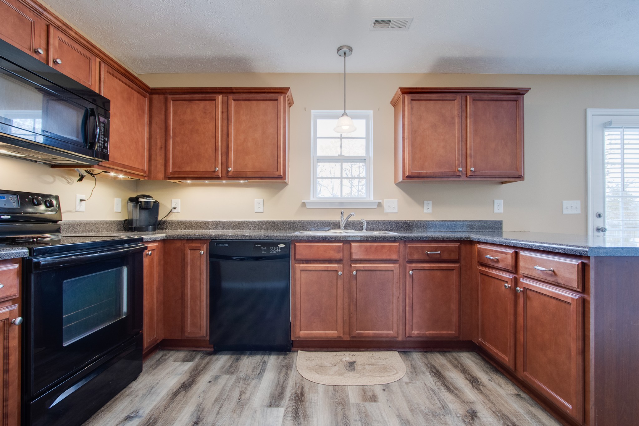 977 Woodall Road Lebanon, TN 37090 - Photo 15 of 32 a kitchen with stainless steel appliances granite countertop wooden cabinets a stove top oven a sink and dishwasher