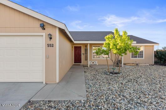 552 Spur Court Fernley, NV 89408 - Photo 4 of 46 a front view of a house with a yard