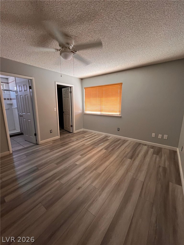 5348 Ravendale Circle Las Vegas, NV 89120 - Photo 11 of 14 A well-lit bedroom features durable laminate flooring and a cooling ceiling fan.