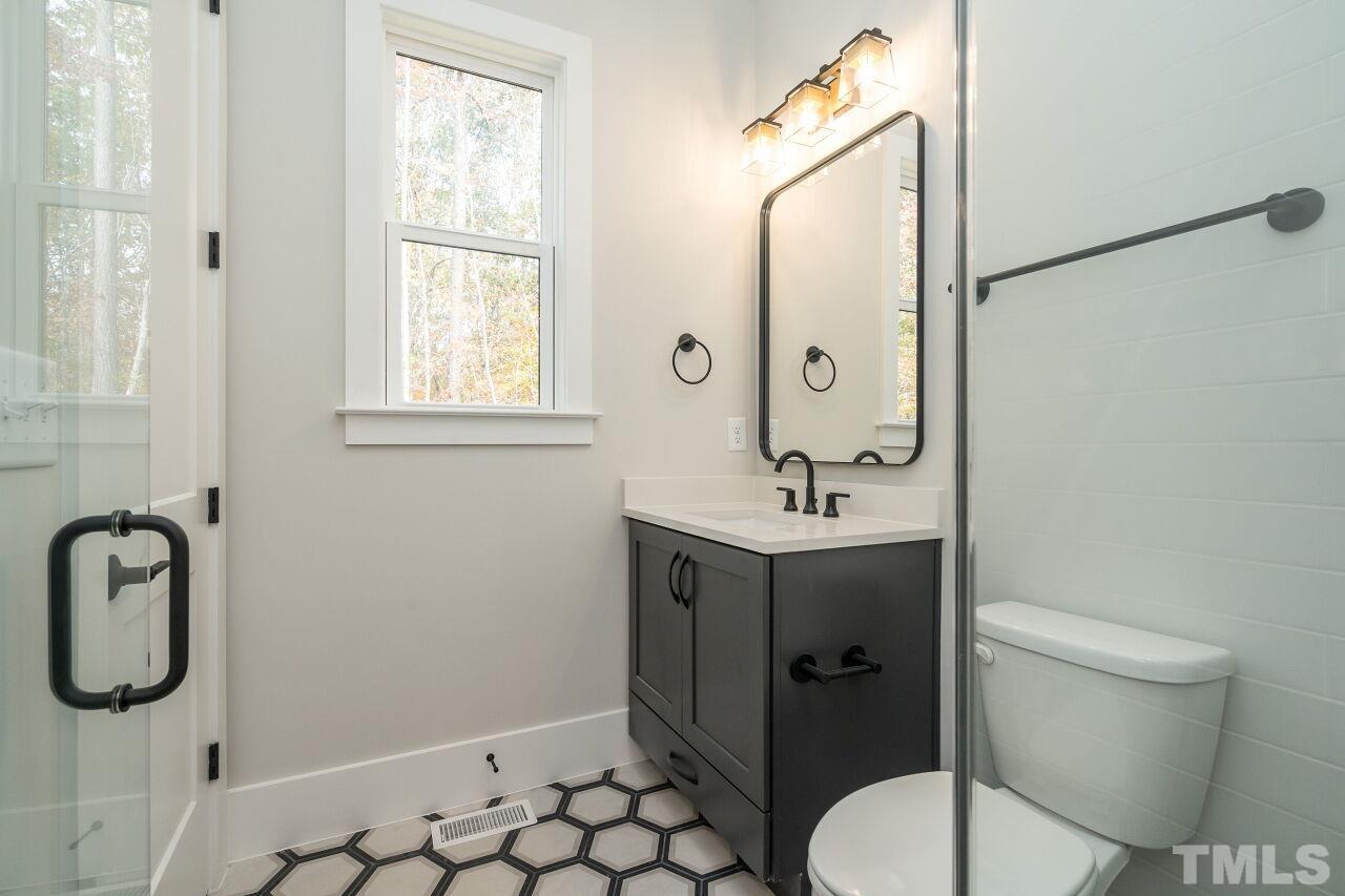 1220 Explorer Trail Wake Forest, NC 27587 - Photo 29 of 49 a bathroom with a granite countertop sink toilet and shower