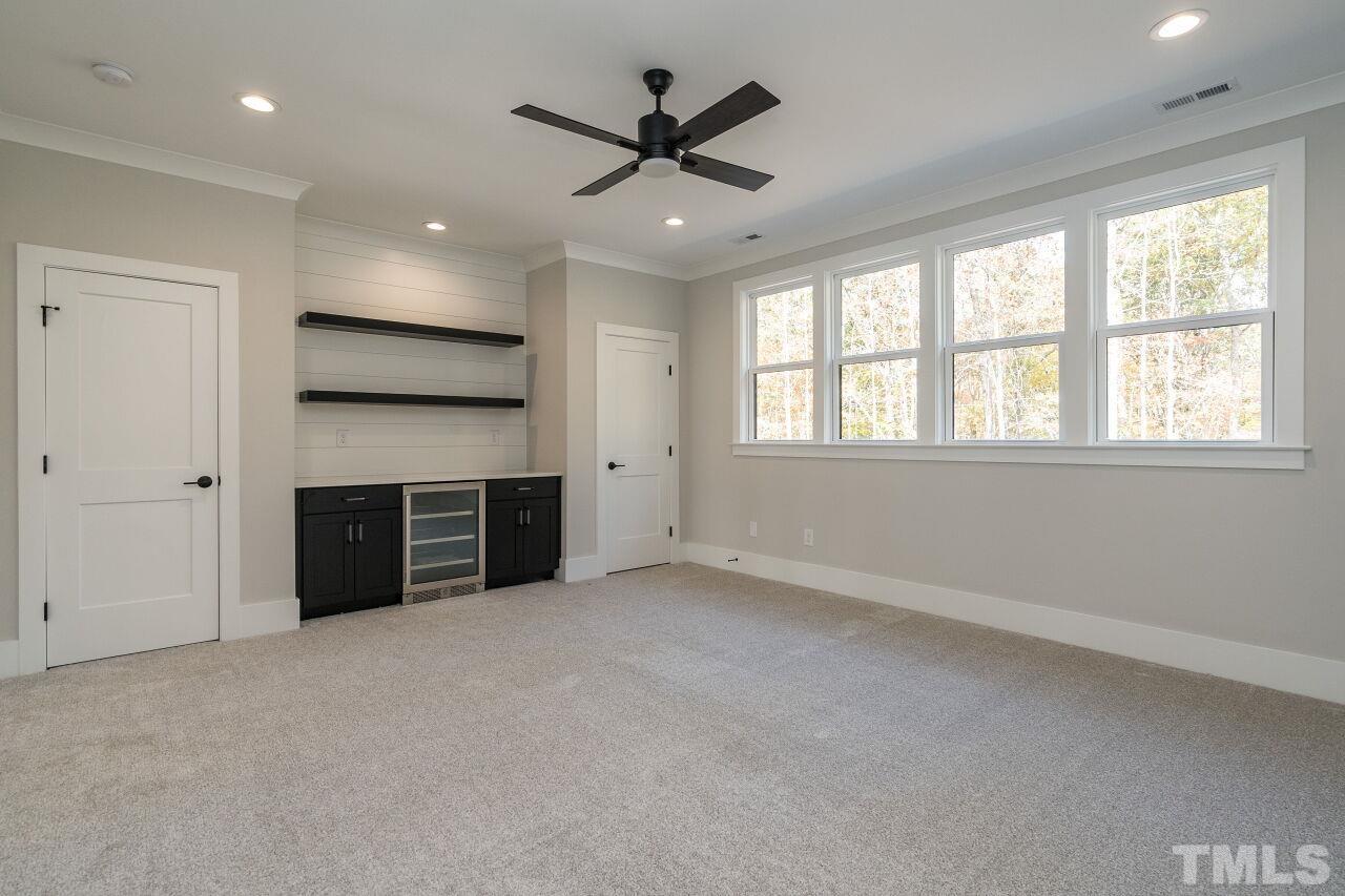 1220 Explorer Trail Wake Forest, NC 27587 - Photo 34 of 49 a view of an empty room with a ceiling fan and window