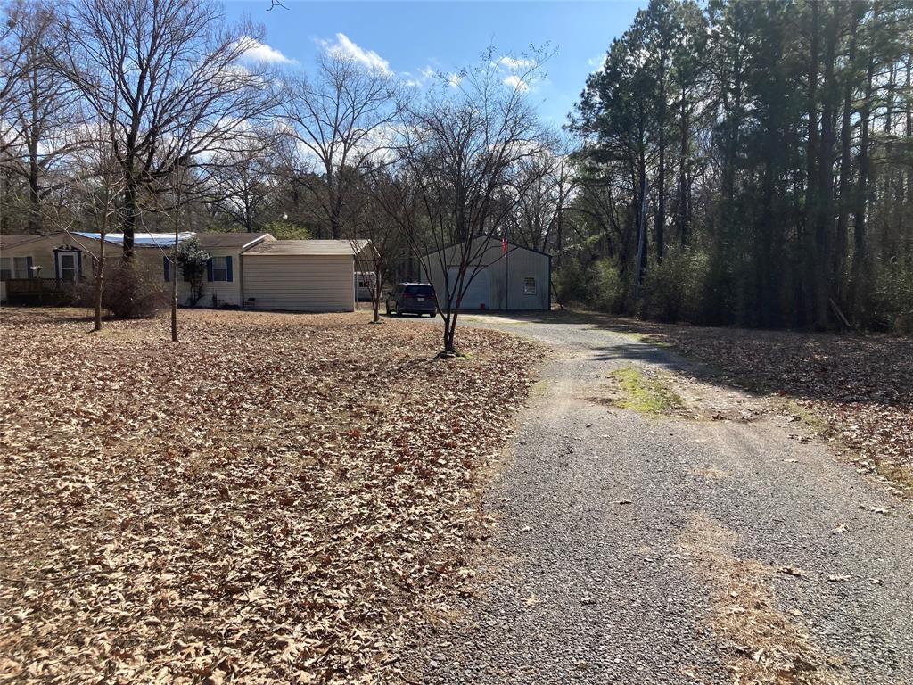 9515 Caddo Lake Road Mooringsport, LA 71060 - Photo 3 of 12 a house with trees in the background