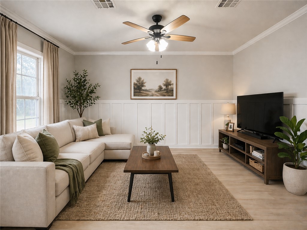 738 Commerce Street Bryan, TX 77803 - Photo 3 of 15 a living room with furniture a flat screen tv and a window