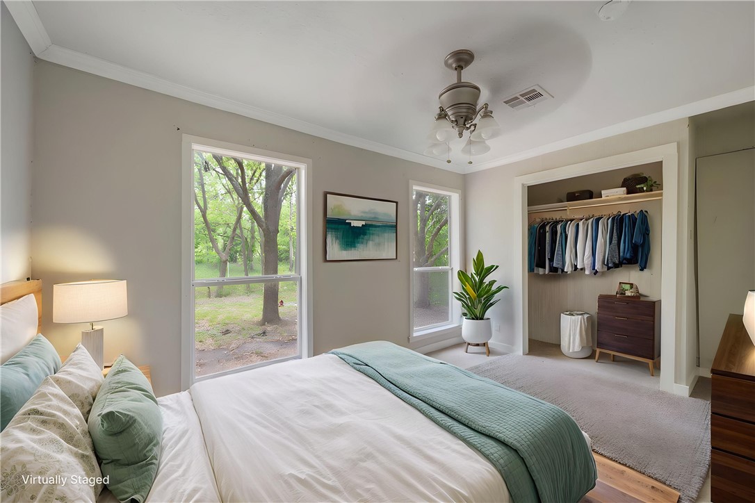 738 Commerce Street Bryan, TX 77803 - Photo 4 of 15 a bedroom with a bed and ceiling fan