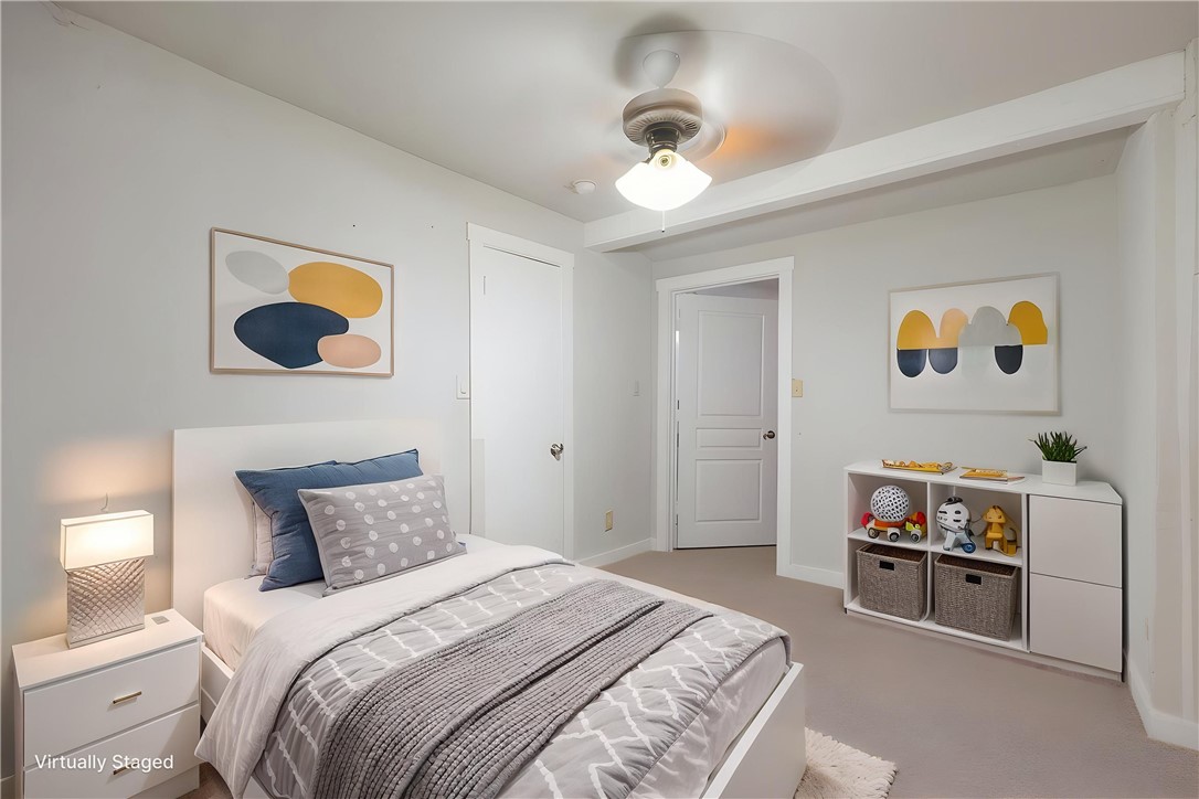 738 Commerce Street Bryan, TX 77803 - Photo 6 of 15 a bedroom with a bed and a chandelier