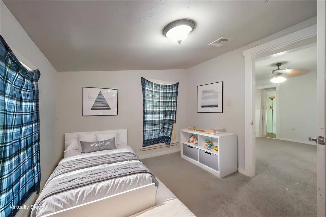 738 Commerce Street Bryan, TX 77803 - Photo 7 of 15 a spacious bedroom with a bed and a lamp