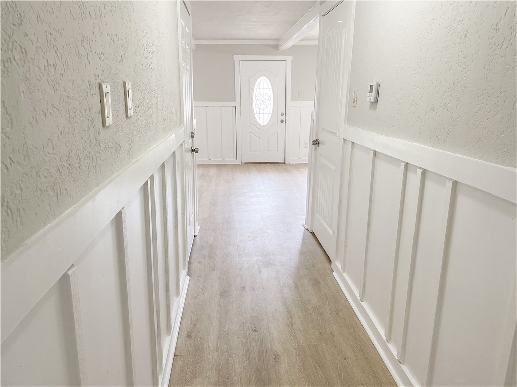 738 Commerce Street Bryan, TX 77803 - Photo 9 of 15 a view of a hallway with wooden floor and staircase