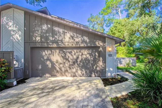 a view of a small house with a tree in front