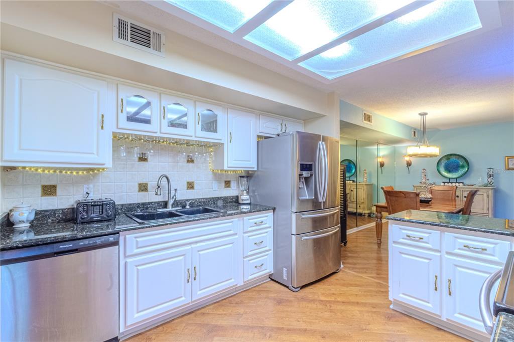 39 Cherokee Trail Ormond Beach, FL 32174 - Photo 11 of 35 a kitchen with stainless steel appliances granite countertop a sink and cabinets