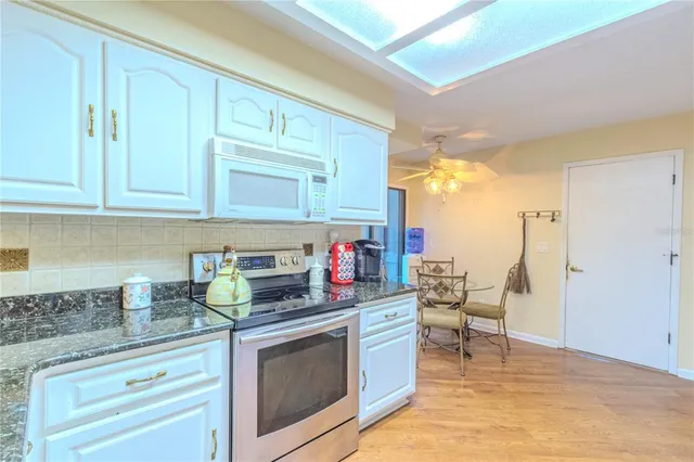 a kitchen with stainless steel appliances granite countertop a stove and a cabinets