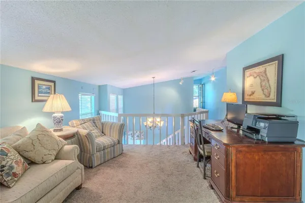 a living room with furniture a lamp and a window
