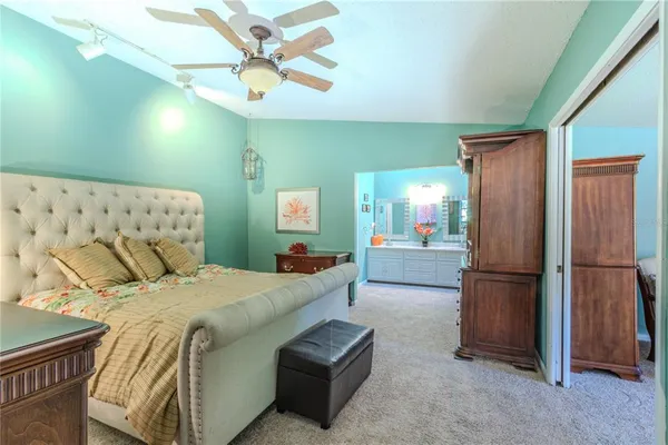 a bedroom with a bed dresser and a shower