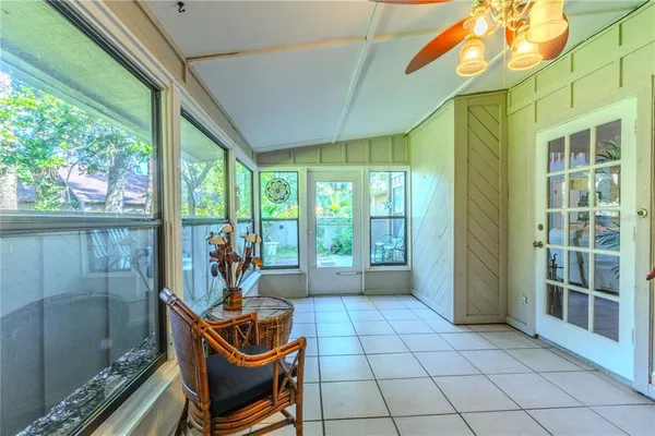 a living room with furniture and a floor to ceiling window