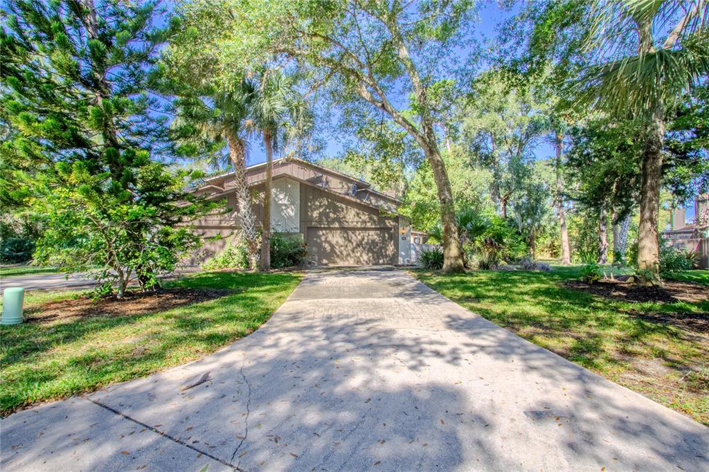 39 Cherokee Trail Ormond Beach, FL 32174 - Photo 34 of 35 a front view of a house with a yard and fountain in middle