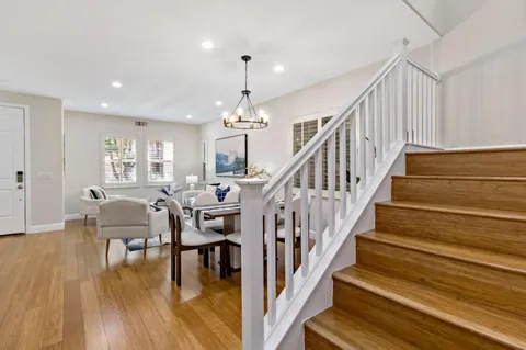 a kitchen with stainless steel appliances kitchen island granite countertop a dining table and chairs