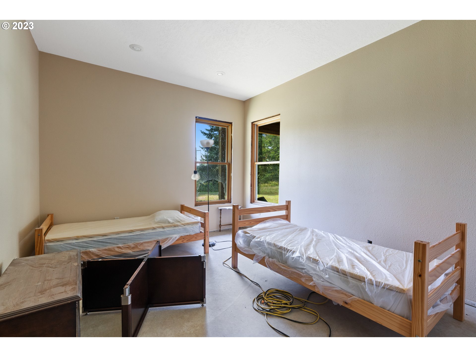 10534 Southeast Vradenburg Road Happy Valley, OR 97086 - Photo 30 of 39 a living room with a bed furniture and a window