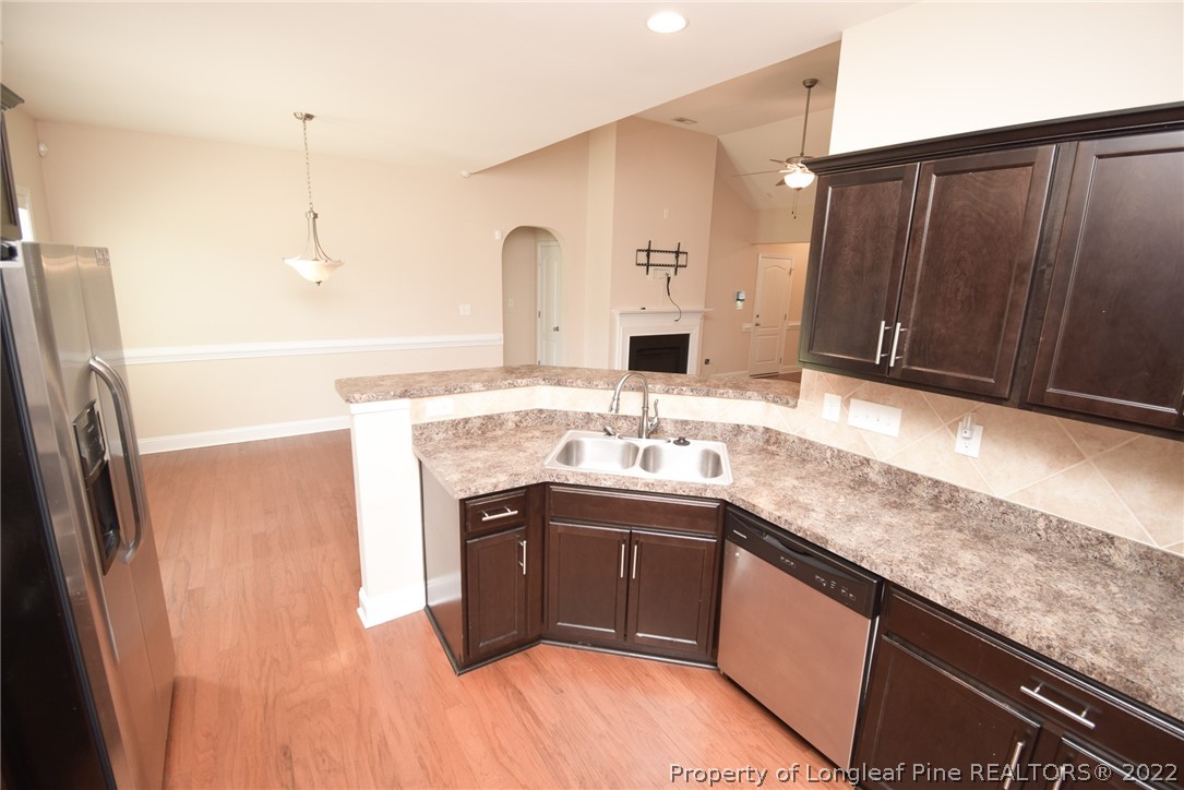 115 Snipe Court Raeford, NC 28376 - Photo 17 of 37 a kitchen with stainless steel appliances granite countertop a sink stove and refrigerator
