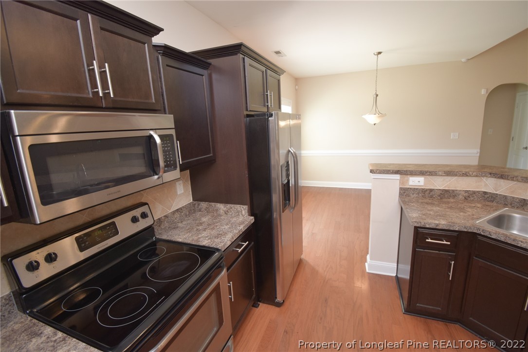 115 Snipe Court Raeford, NC 28376 - Photo 18 of 37 a kitchen with a stove microwave and refrigerator