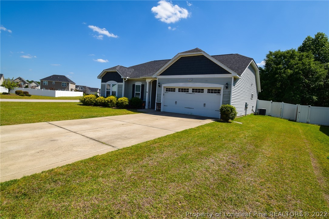 115 Snipe Court Raeford, NC 28376 - Photo 2 of 37 a front view of a house with a garden and yard