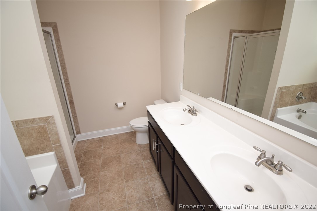115 Snipe Court Raeford, NC 28376 - Photo 27 of 37 a bathroom with a sink and a mirror