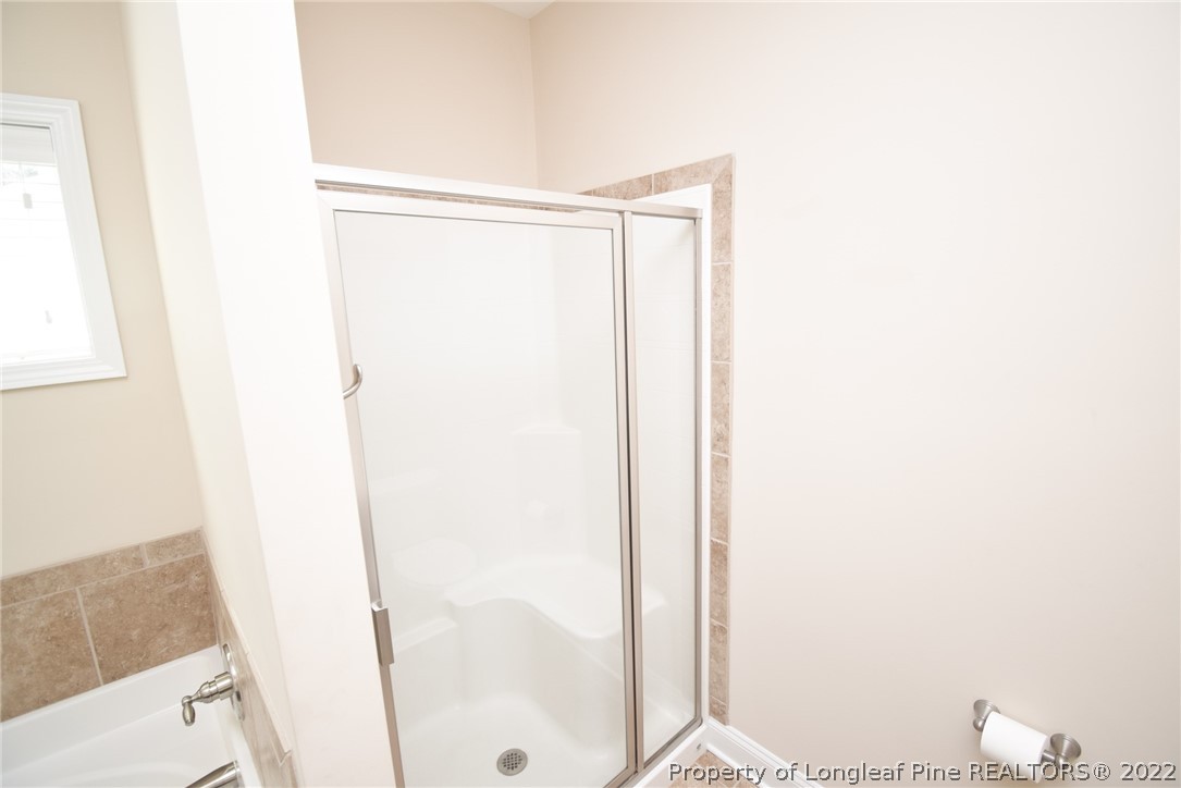 115 Snipe Court Raeford, NC 28376 - Photo 28 of 37 a bathroom with a shower and a toilet