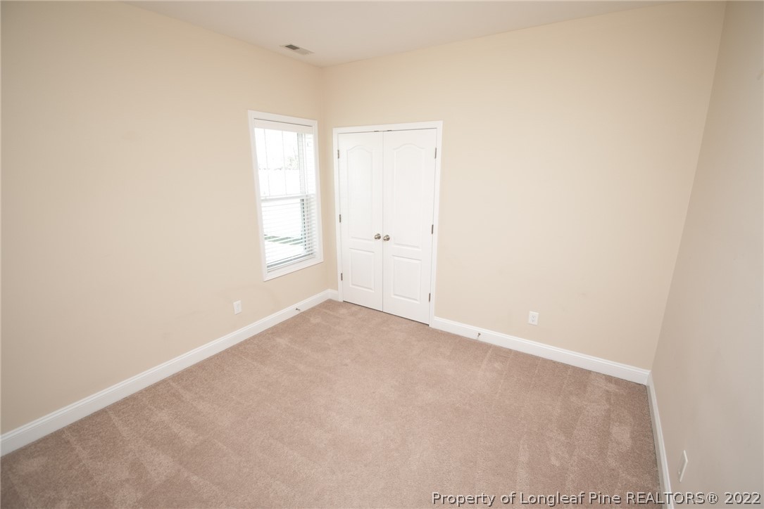 115 Snipe Court Raeford, NC 28376 - Photo 32 of 37 an empty room with windows and closet