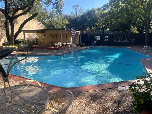 a view of yard with swimming pool and sitting area