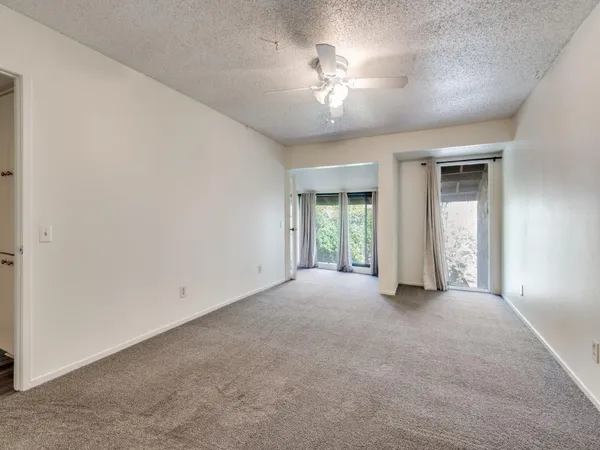 a view of an empty room with a chandelier