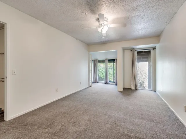a view of an empty room with a chandelier