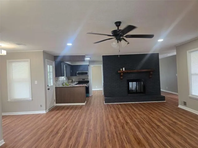 a kitchen with stainless steel appliances granite countertop a refrigerator and a stove top oven