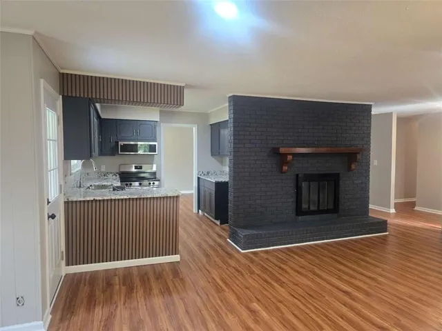 a kitchen with granite countertop a stove and a refrigerator
